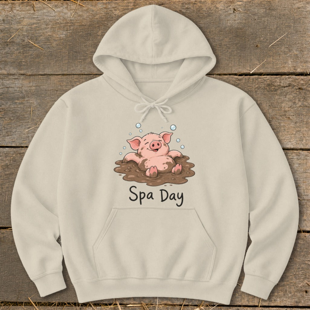Beige hoodie with a cartoon pig enjoying a mud bath, text "Spa Day".