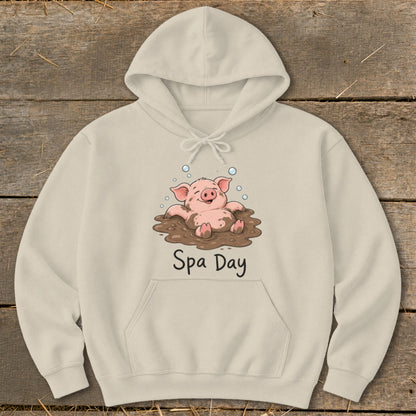 Beige hoodie with a cartoon pig enjoying a mud bath, text "Spa Day".