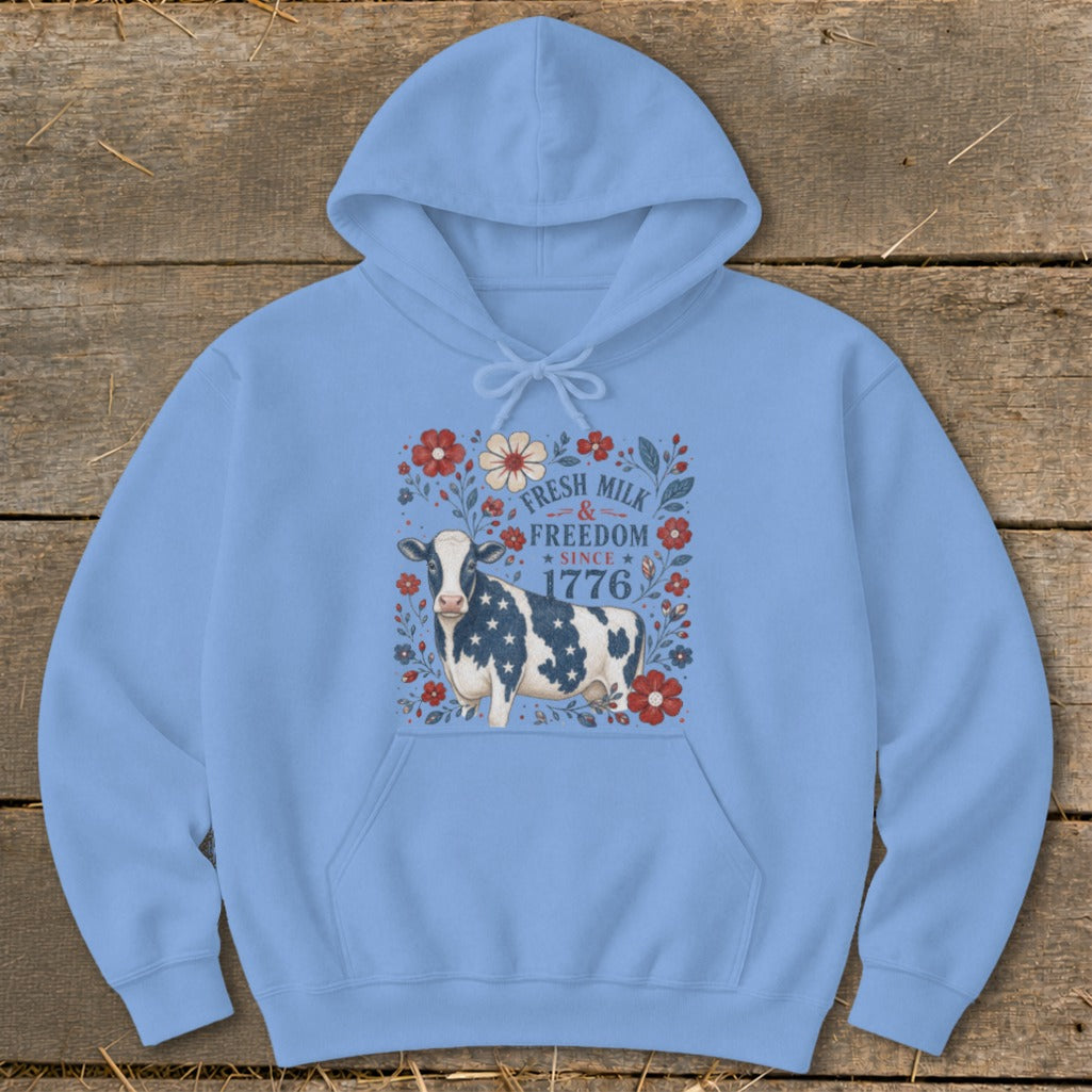 Light blue hoodie with a cow wearing a star-spangled pattern and "Fresh Milk & Freedom Since 1776".