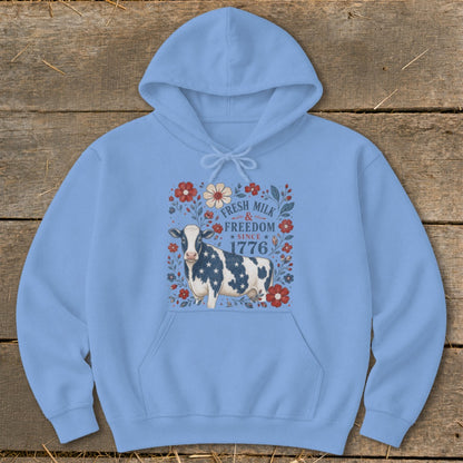 Light blue hoodie with a cow wearing a star-spangled pattern and "Fresh Milk & Freedom Since 1776".