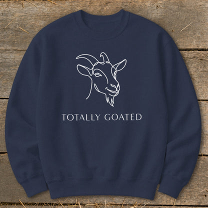 Navy sweatshirt with white line drawing of a goat and "TOTALLY GOATED" text.