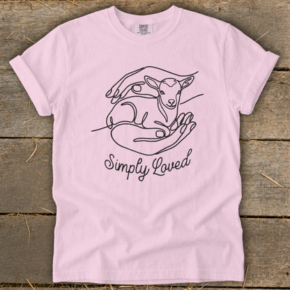 Pink t-shirt with line art of hands holding a lamb and "Simply Loved" text.
