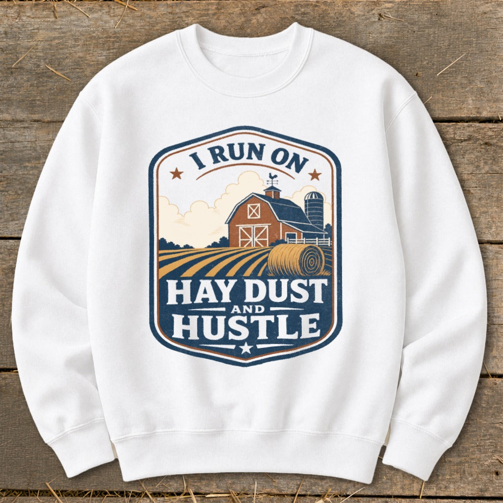 White sweatshirt with "I Run On Hay Dust And Hustle" farm graphic.