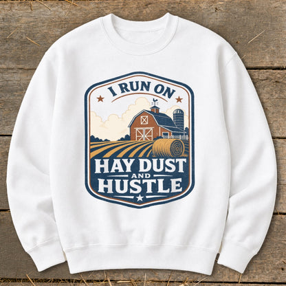 White sweatshirt with "I Run On Hay Dust And Hustle" farm graphic.