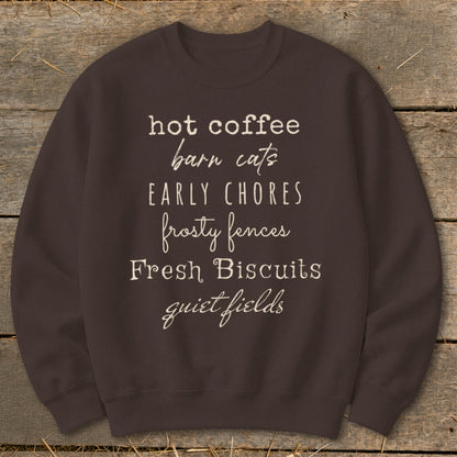 Brown sweatshirt with text: hot coffee, barn cats, EARLY CHORES, frosty fences, Fresh Biscuits, quiet fields.