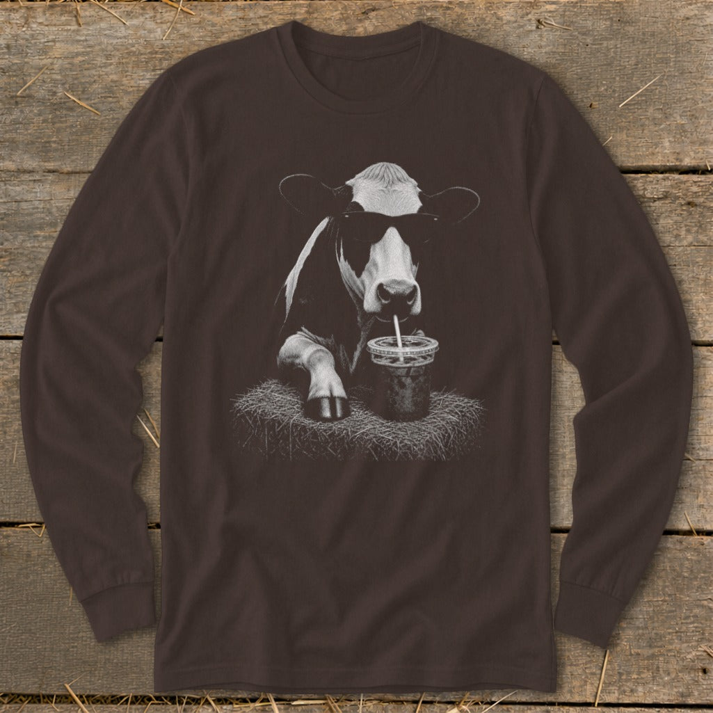 Cow wearing sunglasses drinking from a cup with a straw.