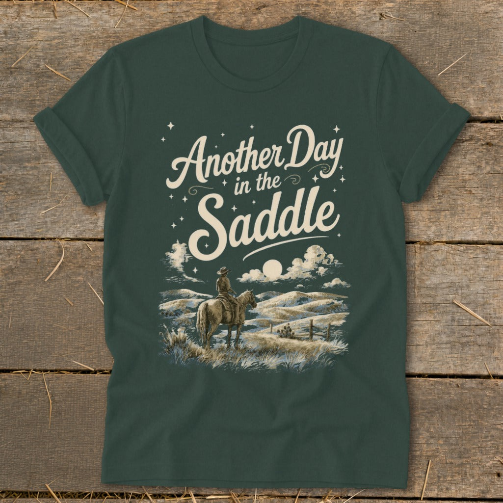 Dark green t-shirt with "Another Day in the Saddle" text and horse rider graphic.