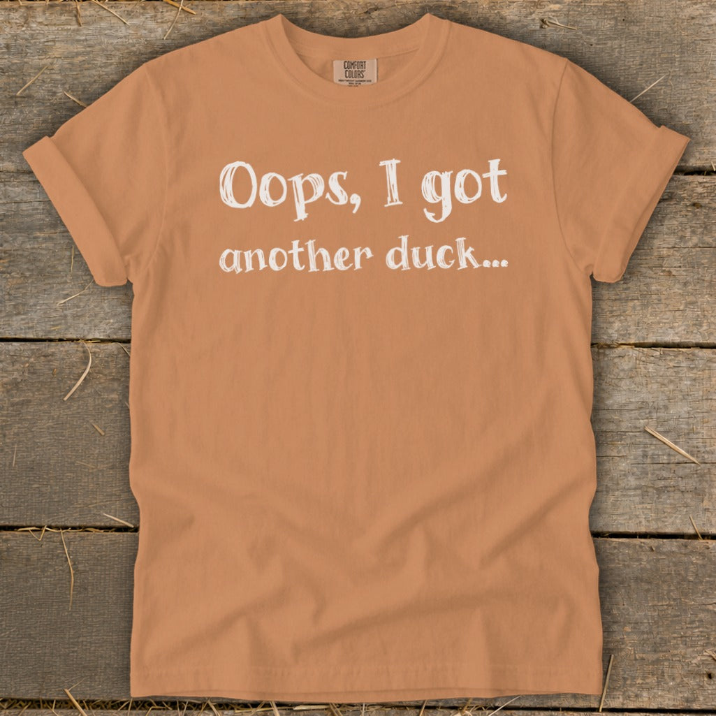 Orange t-shirt with white text: "Oops, I got another duck..."