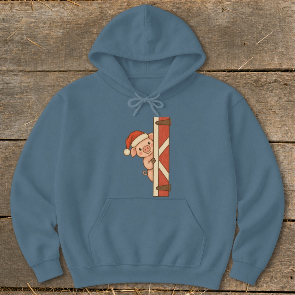 Blue hoodie with a cute pig wearing a Santa hat peeking around a barn door.