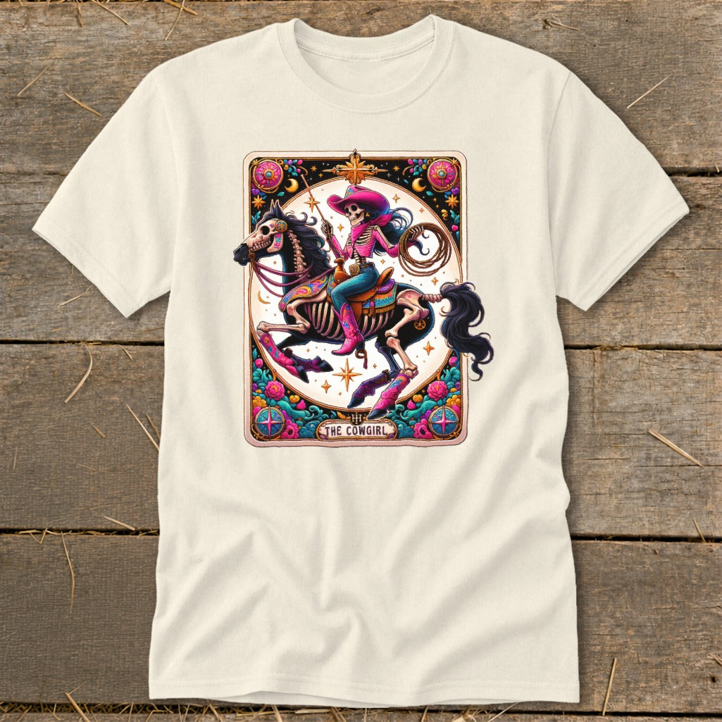 T-shirt graphic of a skeleton cowgirl riding a horse, with text "The Cowgirl".