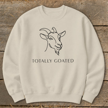 Cream sweatshirt with a black line drawing of a goat's head and text "TOTALLY GOATED".