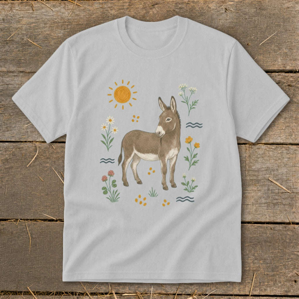 Light gray t-shirt with a watercolor illustration of a donkey surrounded by flowers and the sun.