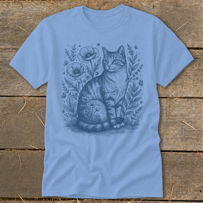 Light blue t-shirt with a sketch of a cat sitting among poppies and butterflies.
