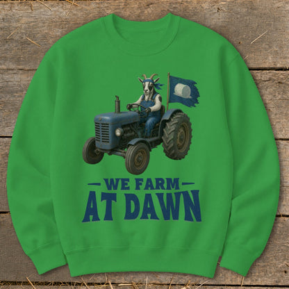 Goat in overalls driving a blue tractor with a flag, "WE FARM AT DAWN" text.
