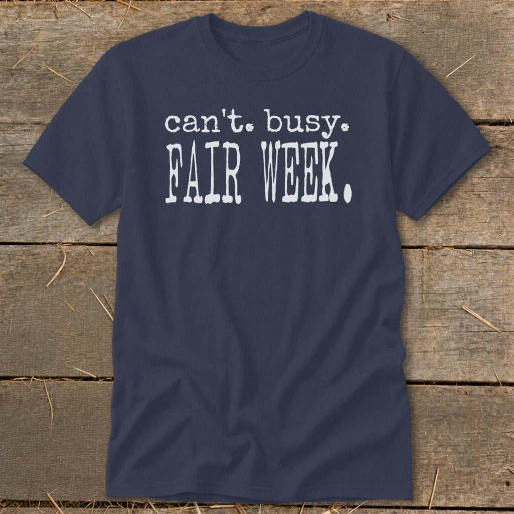 Navy blue t-shirt with white text: "can't. busy. FAIR WEEK."