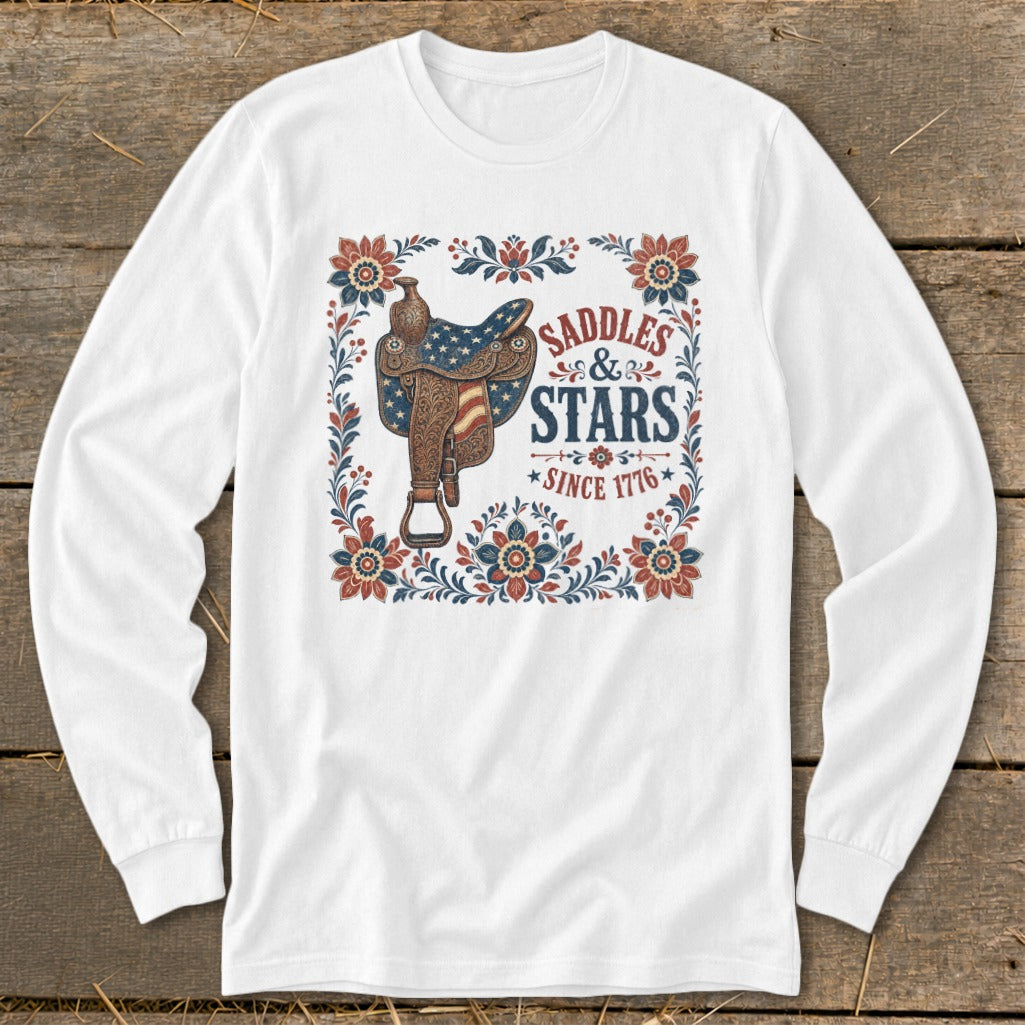White long-sleeve shirt with "Saddles & Stars Since 1776" text and patriotic saddle graphic.