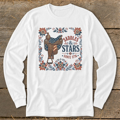 White long-sleeve shirt with "Saddles & Stars Since 1776" text and patriotic saddle graphic.