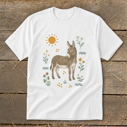 White t-shirt with a watercolor donkey illustration surrounded by flowers, sun, and wavy lines.