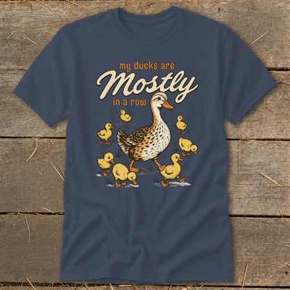 T-shirt graphic with a mother duck and ducklings and text "my ducks are Mostly in a row".