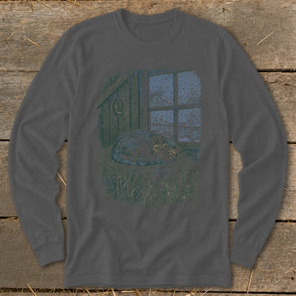 Cat sleeping on hay in front of a window with falling snow.