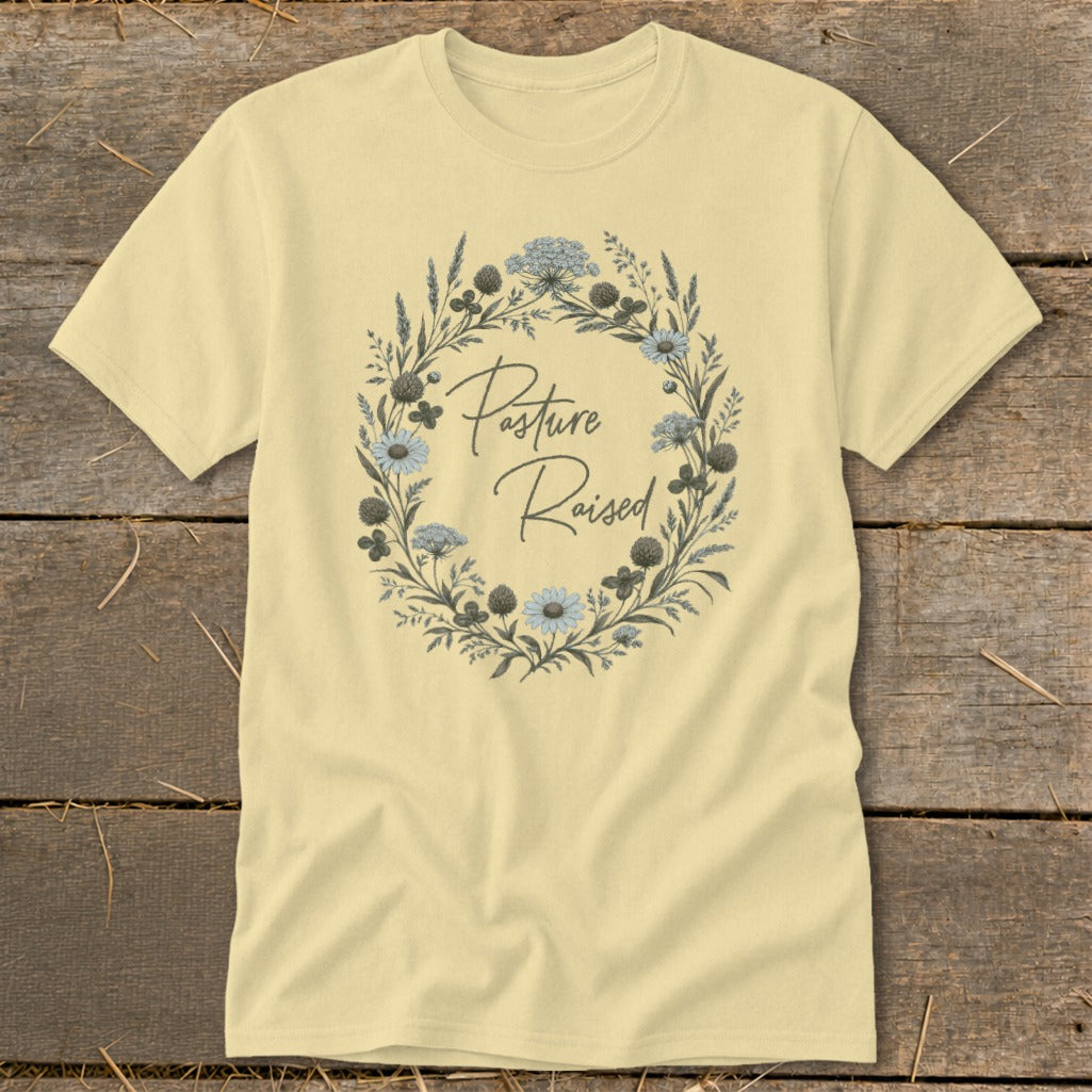 Pale yellow t-shirt with a floral wreath graphic and "Pasture Raised" text.