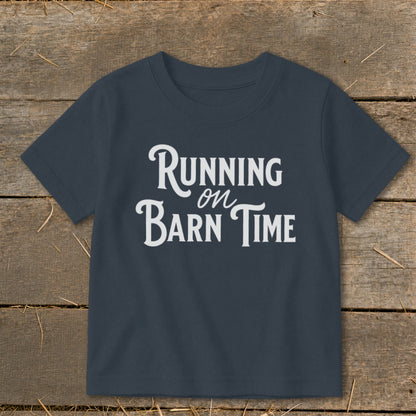 Navy t-shirt with white text "Running on Barn Time" on a wooden background.