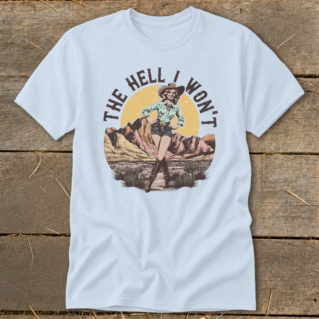 Cowgirl illustration with text "THE HELL I WON'T" on a light blue t-shirt.