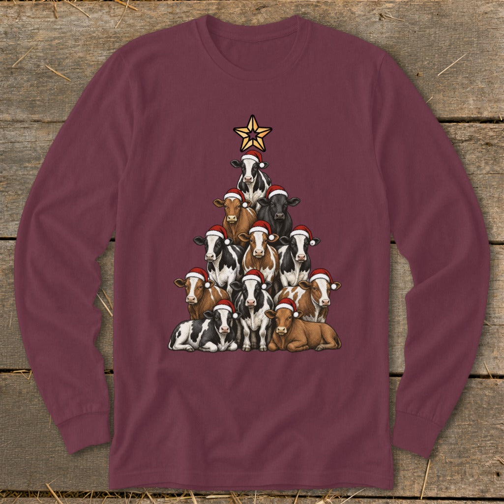 Cows in Santa hats stacked into a Christmas tree with a star on top.