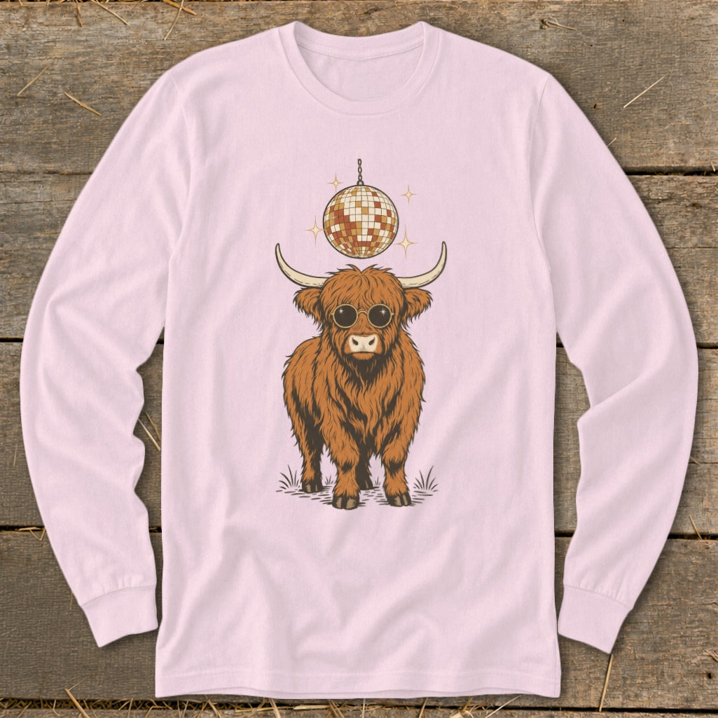 Long sleeve pink shirt with graphic of shaggy Highland cow wearing sunglasses and a disco ball.