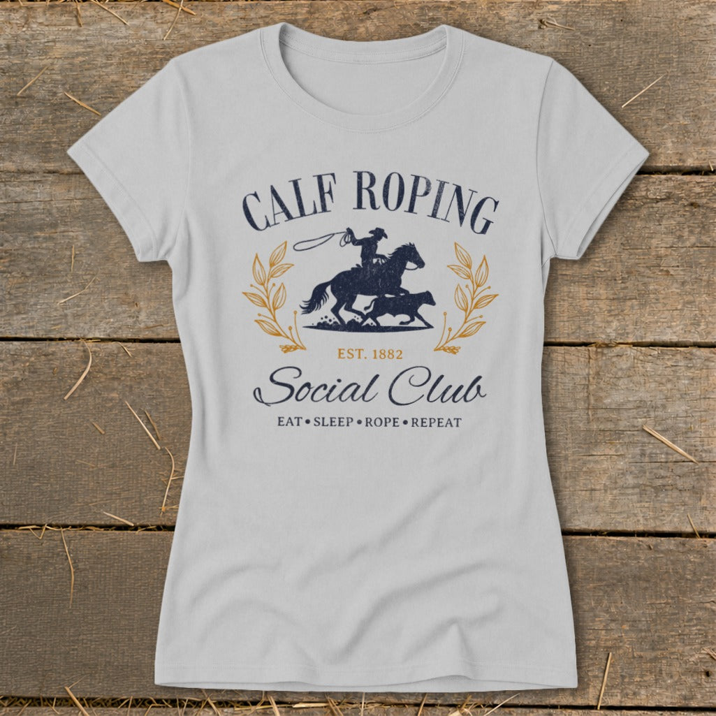 Calf Roping Social Club graphic on light grey t-shirt with cowboy on horse roping calf.