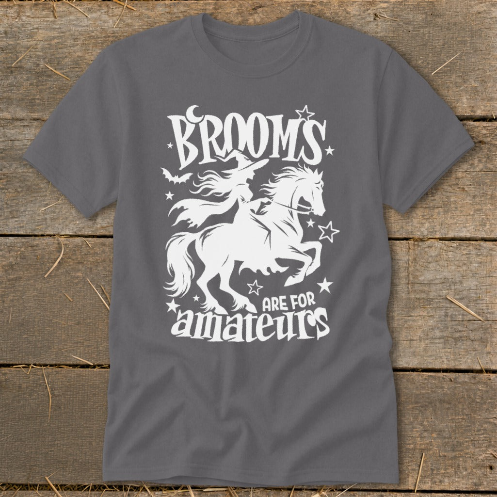 White graphic on gray t-shirt: Witch on horse, "Brooms are for amateurs."