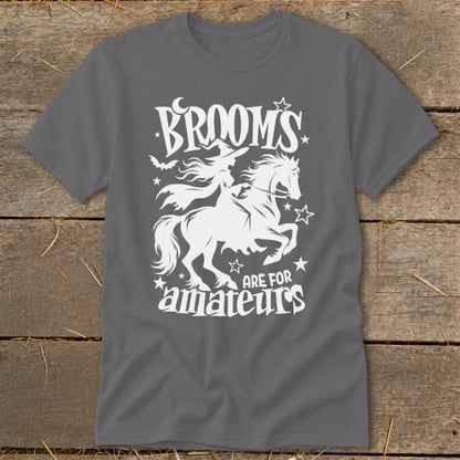 White graphic on gray t-shirt: Witch on horse, "Brooms are for amateurs."