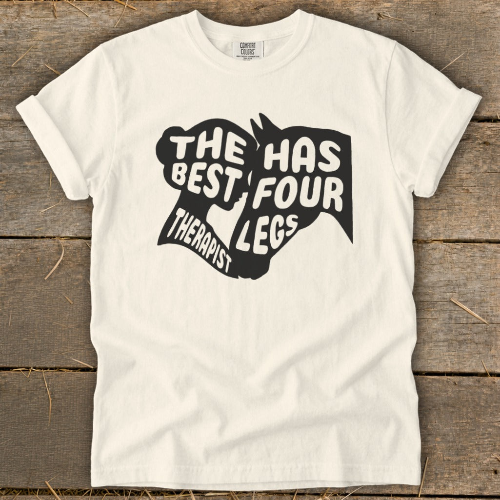 Cream t-shirt with black text graphic: "The best therapist has four legs."