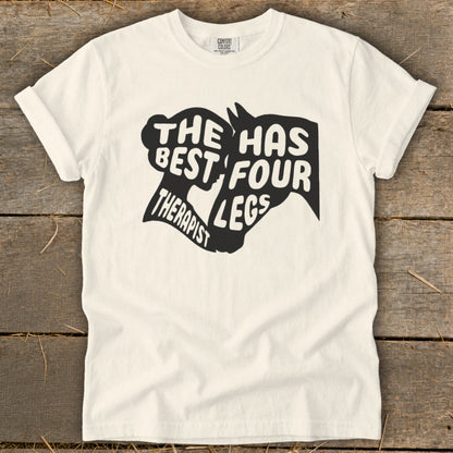 Cream t-shirt with black text graphic: "The best therapist has four legs."