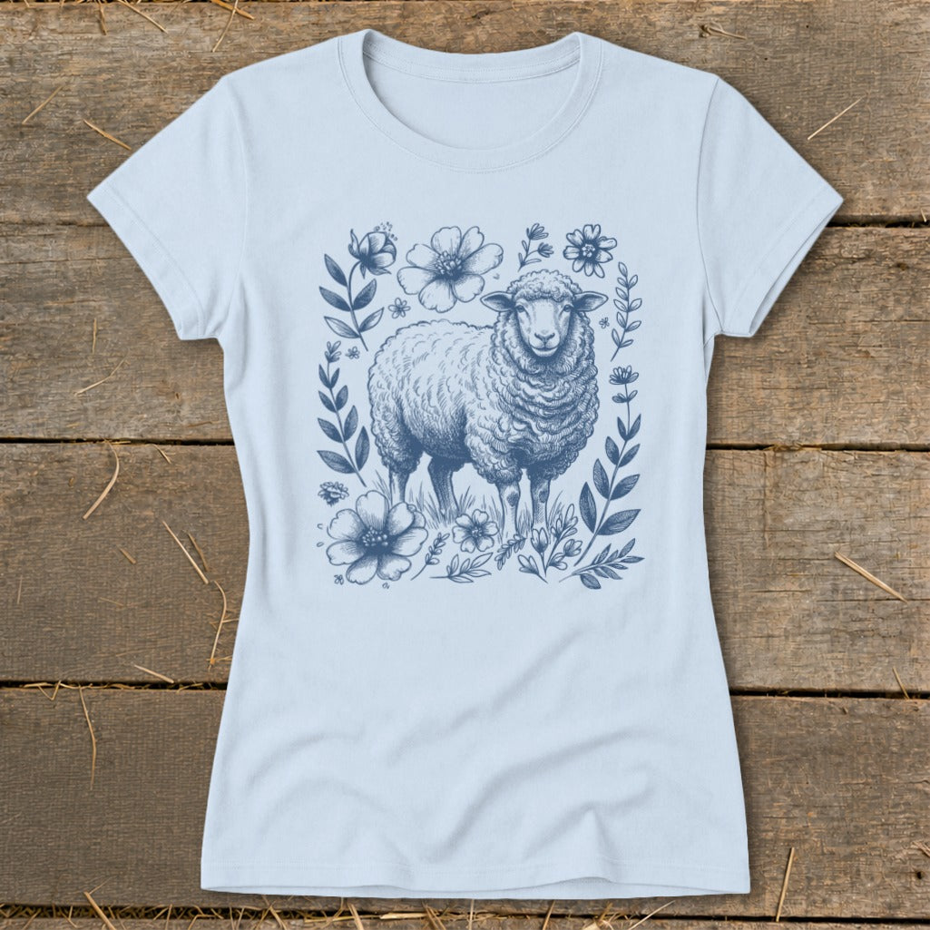 Light blue t-shirt with a detailed sketch of a sheep surrounded by flowers and leaves.