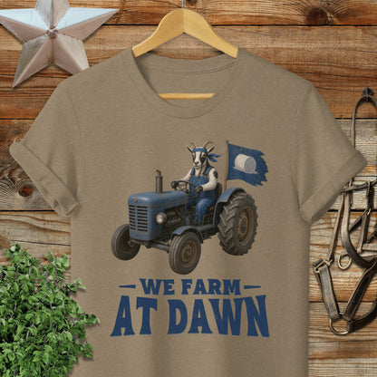 T-shirt with goat in tractor flying "We Farm At Dawn" flag.