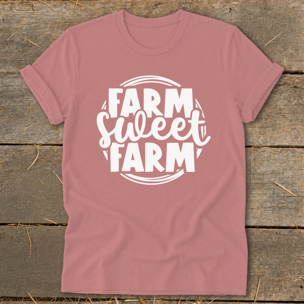Pink t-shirt with white text that reads "Farm Sweet Farm" in a circular design.