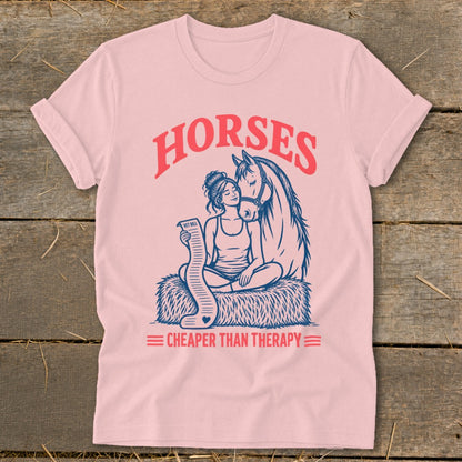 Pink t-shirt with graphic of woman and horse, text "Horses Cheaper Than Therapy"
