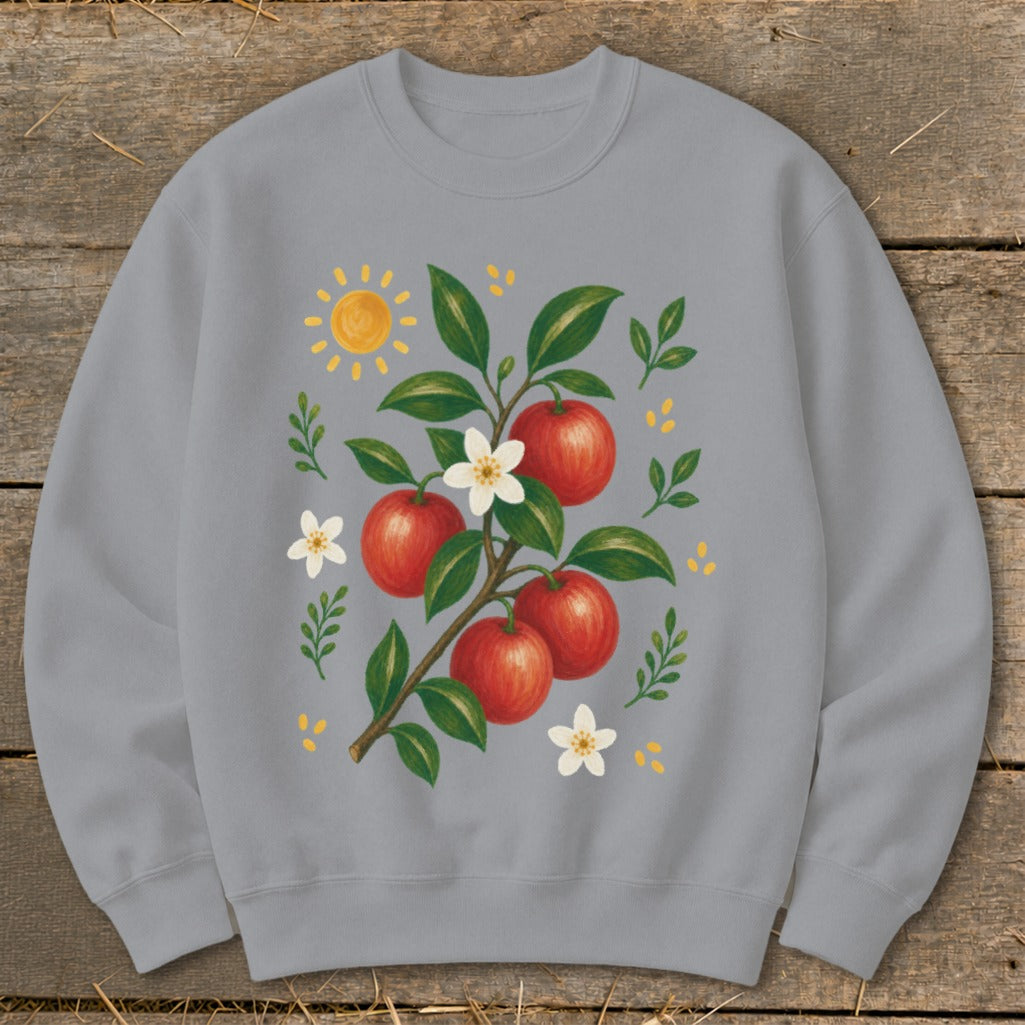 Grey sweatshirt with a painterly illustration of red apples on a branch with flowers and sun.