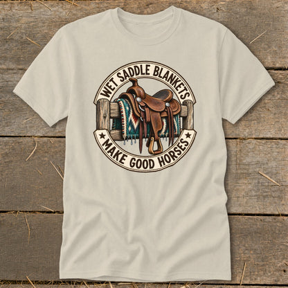 T-shirt graphic with saddle, blanket, fence and text "Wet Saddle Blankets Make Good Horses."