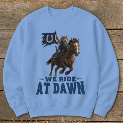 Cat in overalls riding a horse, holding a tattered flag with a horseshoe. "We Ride At Dawn".