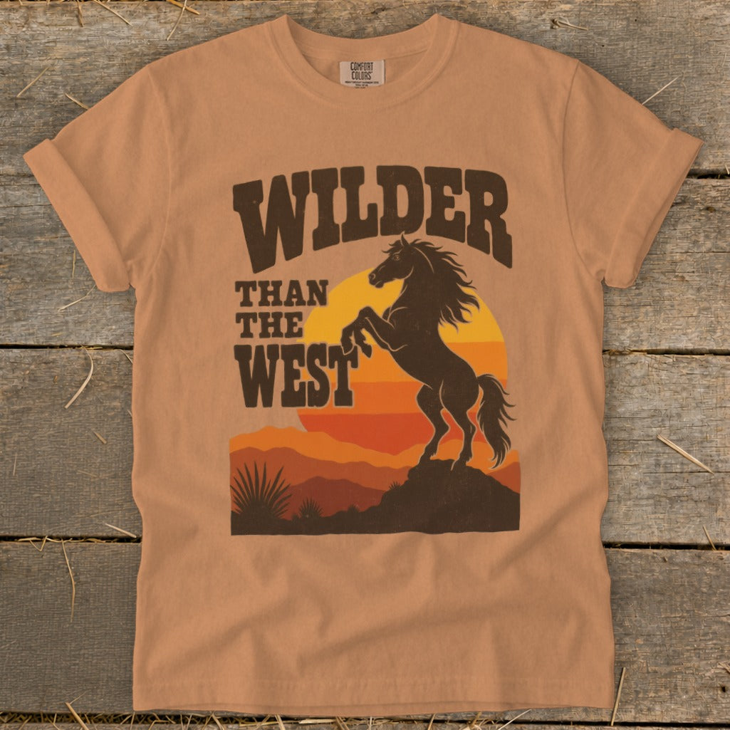 Orange t-shirt with "Wilder Than The West" text and a rearing horse silhouette.