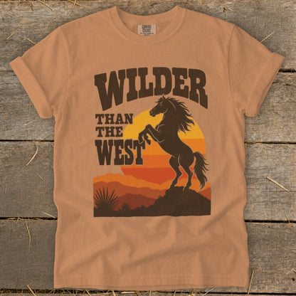 Orange t-shirt with "Wilder Than The West" text and a rearing horse silhouette.