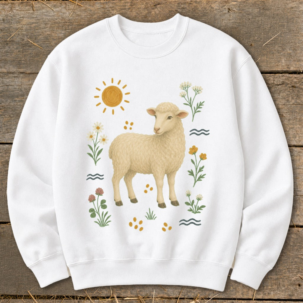 White sweatshirt with a cream-colored sheep surrounded by flowers, sun, and water ripples.