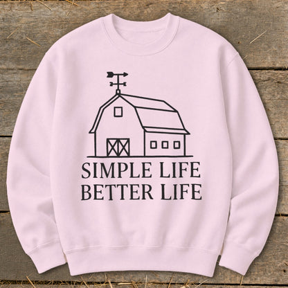 Pink sweatshirt with a barn graphic and text "SIMPLE LIFE BETTER LIFE".