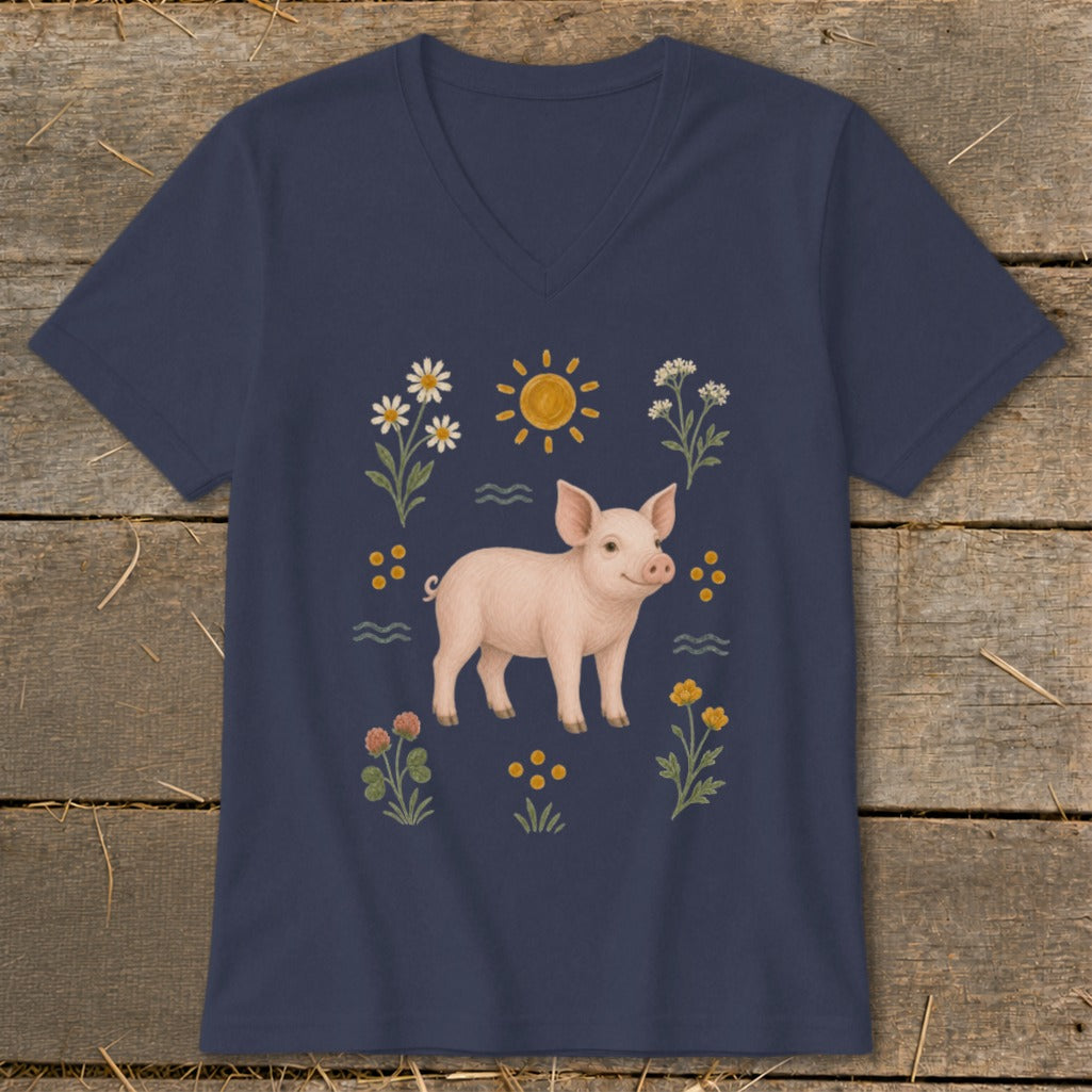 Navy t-shirt with a pink pig illustration surrounded by flowers and a sun.