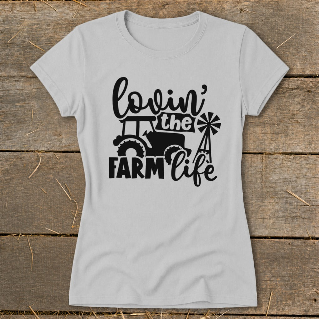 Light grey t-shirt with black graphic of tractor, windmill, and text "lovin' the FARM life".