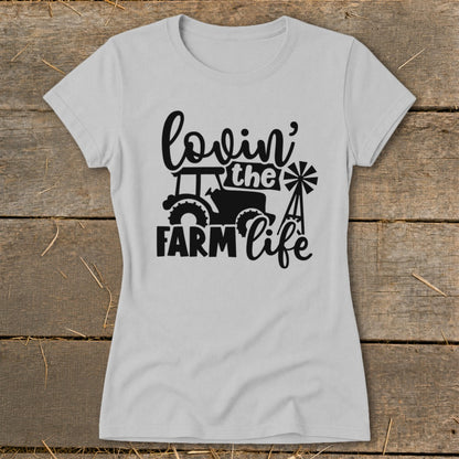 Light grey t-shirt with black graphic of tractor, windmill, and text "lovin' the FARM life".