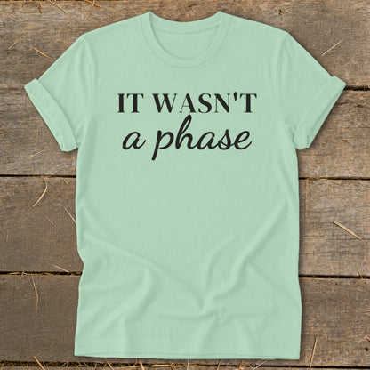 Light green t-shirt with black text "IT WASN'T a phase".