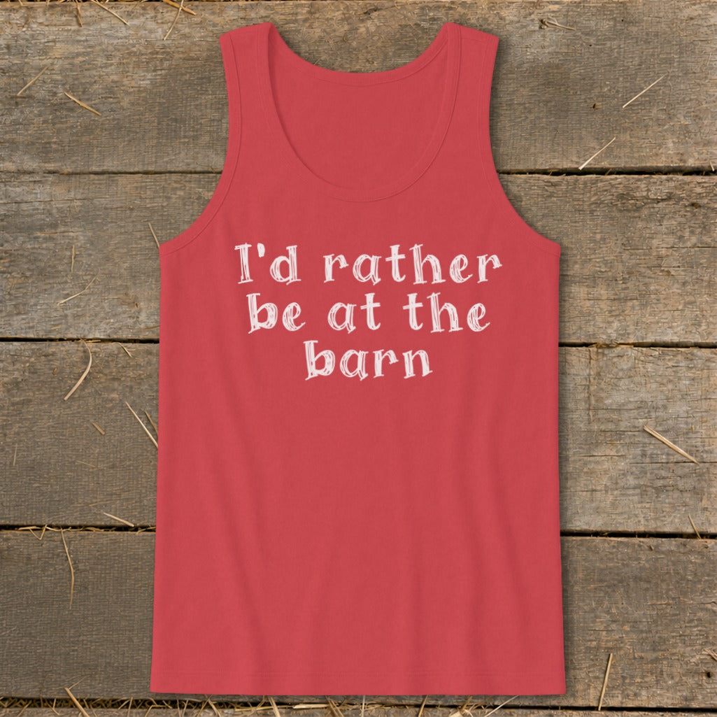 Coral tank top with white text "I'd rather be at the barn" on rustic wooden background.